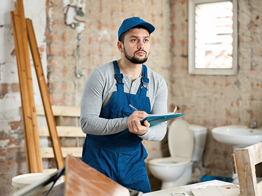 Construction worker planning bathroom renovation